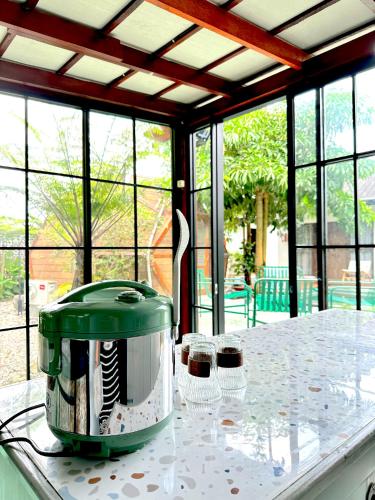 a toaster sitting on a kitchen counter with two glasses at Karuna Villa Prambanan in Yogyakarta