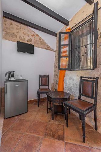a room with two chairs and a table and a refrigerator at Saint Michel Hotel in Rhodes Town
