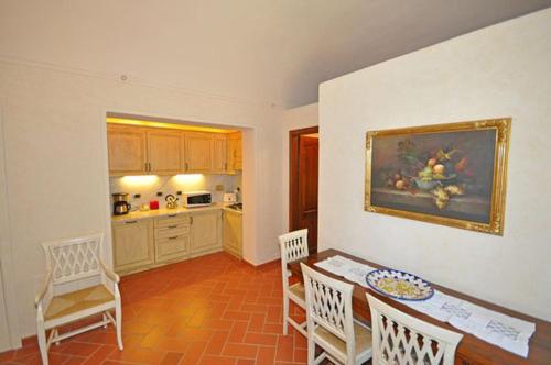 a kitchen and dining room with a table and chairs at Relais Villa Sensano in Pignano
