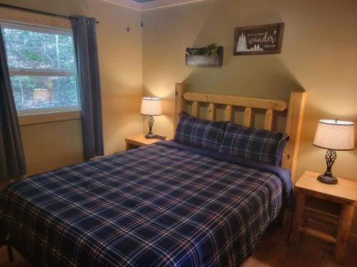 a bedroom with a bed and two lamps and a window at Mountainside Cabin, Secluded, Hot Tub, Lake Accessible in Rockbridge