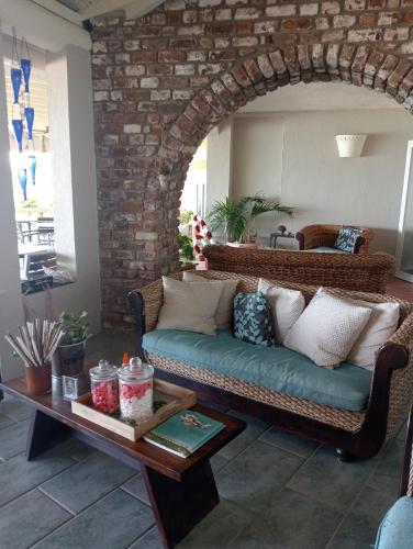 a living room with a couch and a table at Northshore Seaside Suites in Saint Johnʼs