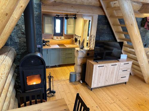 a kitchen with a wood stove in a room at A mon Chalet in Vărşag