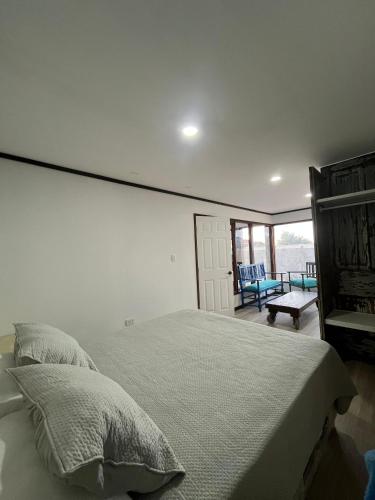 a bedroom with a large bed and a balcony at Apartamento modular independiente in Coquimbo