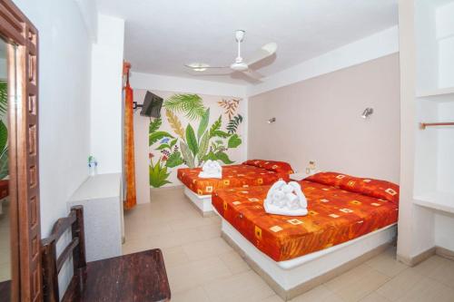 Postel nebo postele na pokoji v ubytování Hotel Galería del Ángel