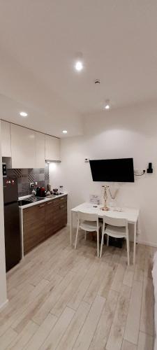 a kitchen with a white table and a white counter top at BARBARA Classy Apartments 103, Wellness in Siracusa