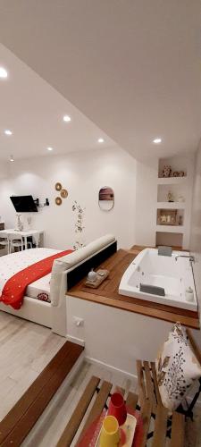 a bedroom with a bed and a bath tub at BARBARA Classy Apartments 103, Wellness in Siracusa