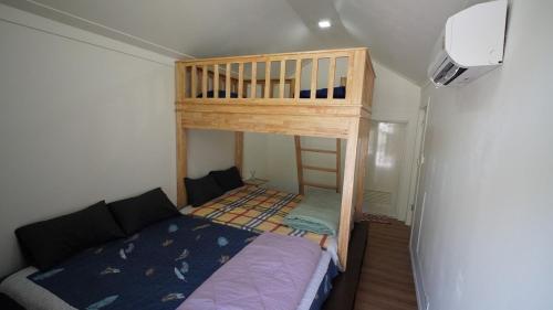 a bedroom with a bunk bed in a room at The Aura Pranburi in Ban Tha Khoi