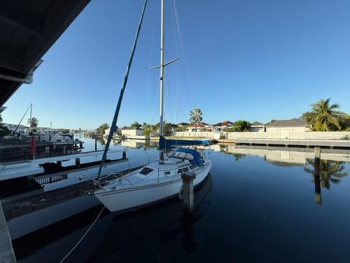 a sailboat is docked at a dock in the water at Luxury Waterfront Villa 431 F in Jolly Harbour