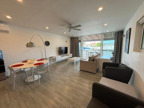 a living room with a table and a dining room at Luxury Waterfront Villa 431 F in Jolly Harbour