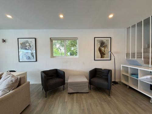 a living room with two chairs and a couch at Luxury Waterfront Villa 431 F in Jolly Harbour