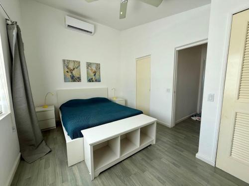 a bedroom with a bed with a blue blanket at Luxury Waterfront Villa 431 F in Jolly Harbour