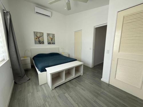 a bedroom with a bed with a blue blanket at Luxury Waterfront Villa 431 F in Jolly Harbour