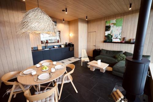 a kitchen and living room with a table and a couch at Висота890 in Volosyanka