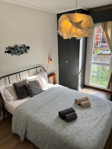 a bedroom with a large bed with two towels on it at Lisbon Woods House II in Lisbon