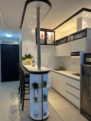 a kitchen with a table with plants on it at Primavera Cozy studio Condominium, Cagayan de Oro City, Philippines in Cagayan de Oro