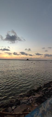 a large body of water with a sunset in the background at Casa 05 quartos Itamaracá com piscina in Itamaracá