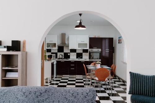a kitchen and dining room with a table and chairs at Elbe Holiday in Donja Stubica