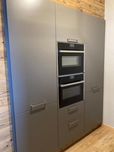 a stainless steel refrigerator with two ovens in it at Bergchalet K2 in Hohentauern