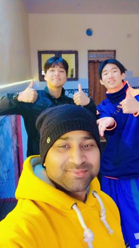 a group of young men giving thumbs up at The Street homestay in Agra