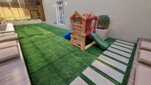 a living room with a pretend play area with a playground at Villa 55 in 6th Of October