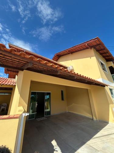 a house with a large parking lot in front of it at Casa Amarela in Penha