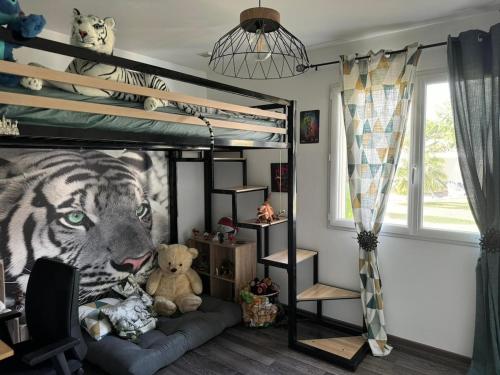 - une chambre avec des lits superposés et une fresque murale représentant des tigres dans l'établissement Luxury villa, à Saint-Sauveur