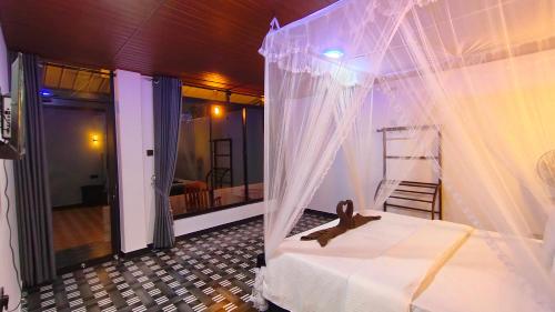a bedroom with a bed with a net at Ella Happy View Homestay in Ella