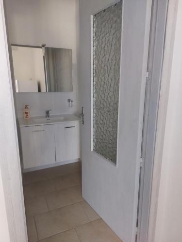 a bathroom with a sink and a mirror at Su Furriadroxiu in San Vito