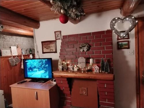 a room with a laptop computer on a brick wall at Vila Lara in Kopaonik