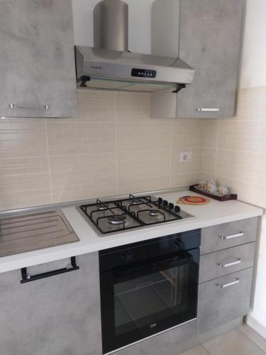 a kitchen with a stove top oven in a kitchen at Su Furriadroxiu in San Vito