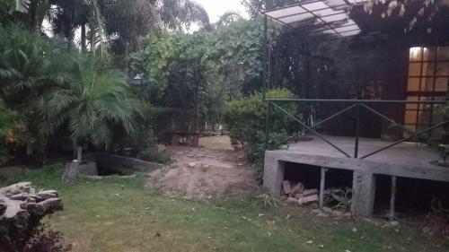 a backyard with a building and a yard with trees at The Wild Escape in Kālādhūngi
