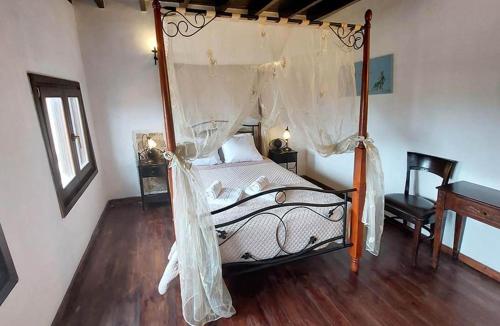 a bedroom with a canopy bed with a wooden floor at Saint Michel Hotel in Rhodes Town