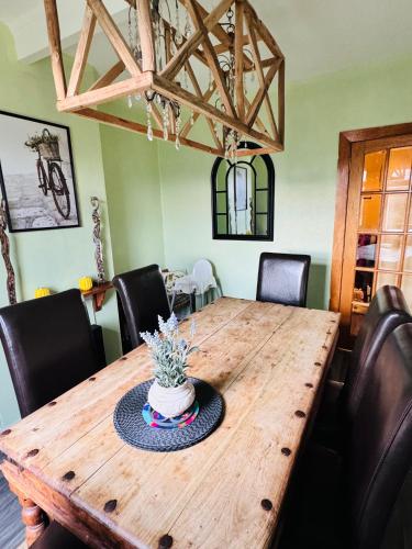 a dining room table with a cake on top of it at Park Road Holiday Home - Spacious 3 bedroom house with garden near Edinburgh in Rosyth