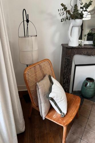 a room with a chair with pillows and a lamp at Villa Louisa in Saint Malo