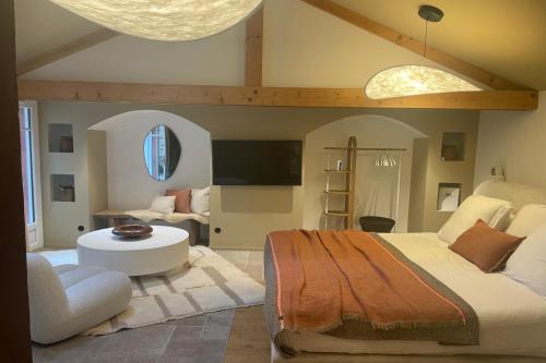 a bedroom with a large bed and a living room at Villa Louisa in Saint Malo