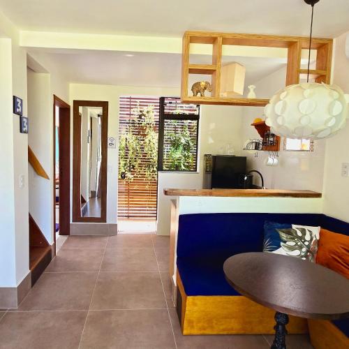 a kitchen with a counter and a table in a room at Krone Garten in Florianópolis