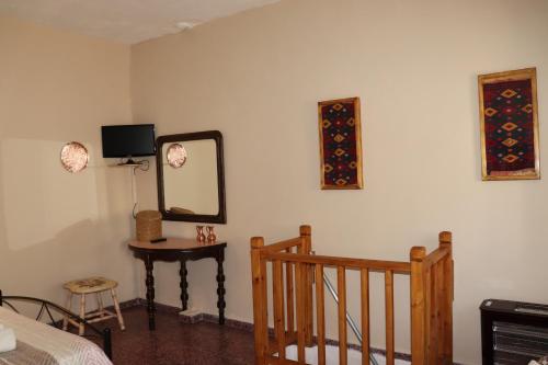 a room with a bed and a mirror and a table at Mary's house in Makrikhórion