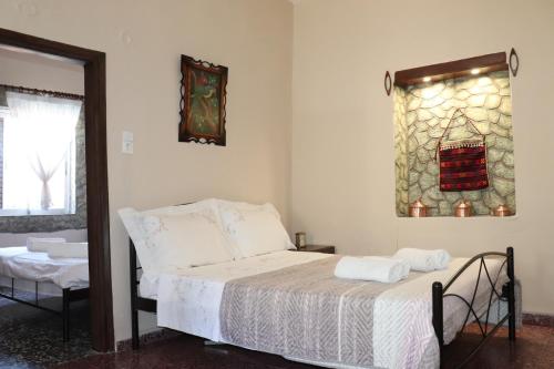 a bedroom with a bed and a window at Mary's house in Makrikhórion