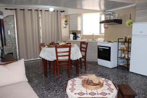 a kitchen and dining room with a table and chairs at Mary's house in Makrikhórion