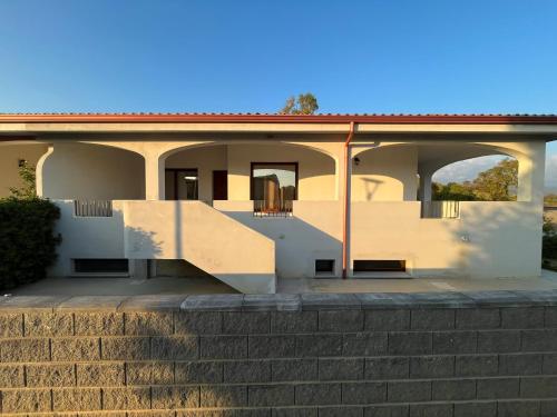 a house with a staircase in front of it at Casa Alma in Porto Pino