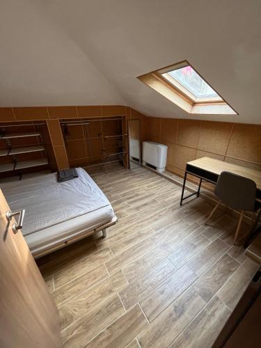 a room with a bed and a table and a window at Hotel MERIDA in Blagoevgrad