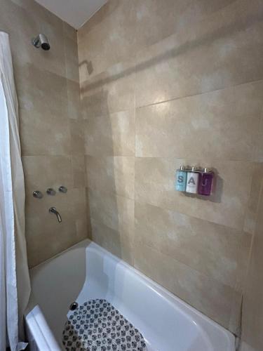 a bathroom with a bath tub with a sink at Tu Espacio in La Plata