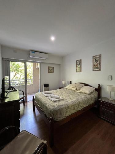 a bedroom with a large bed and a window at Tu Espacio in La Plata