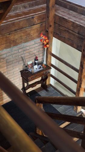 a wooden stairs with a table with flowers on it at B&B Al Vecchio Molino in Valbrembo
