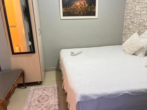a small room with a bed and a window at Oteng Lifestyle BnB in Rustenburg