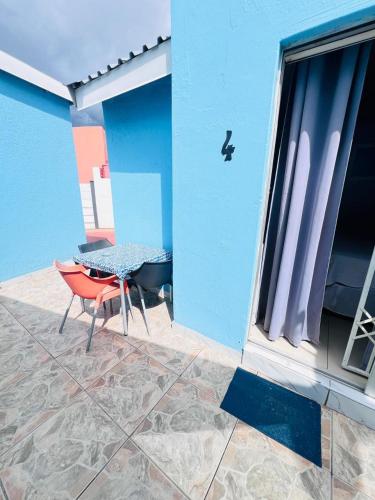a patio with a table and a chair on a building at Oteng Lifestyle BnB in Rustenburg