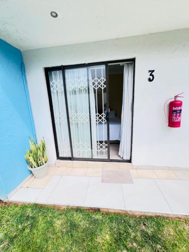 a front door of a house with a window at Oteng Lifestyle BnB in Rustenburg