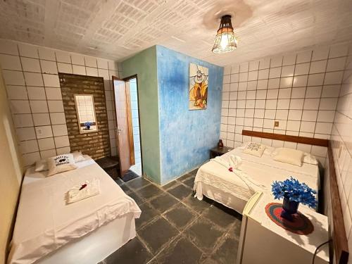 Ein Bett oder Betten in einem Zimmer der Unterkunft Pousada Sol Nascente