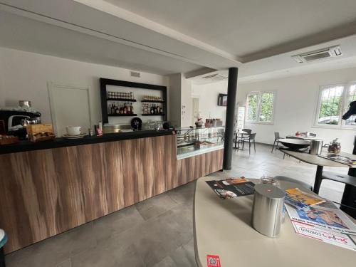 a kitchen with a bar and a dining room at Ca Rossa in Bondeno