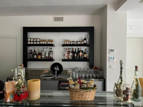 a bar with a counter with bottles of alcohol at Ca Rossa in Bondeno